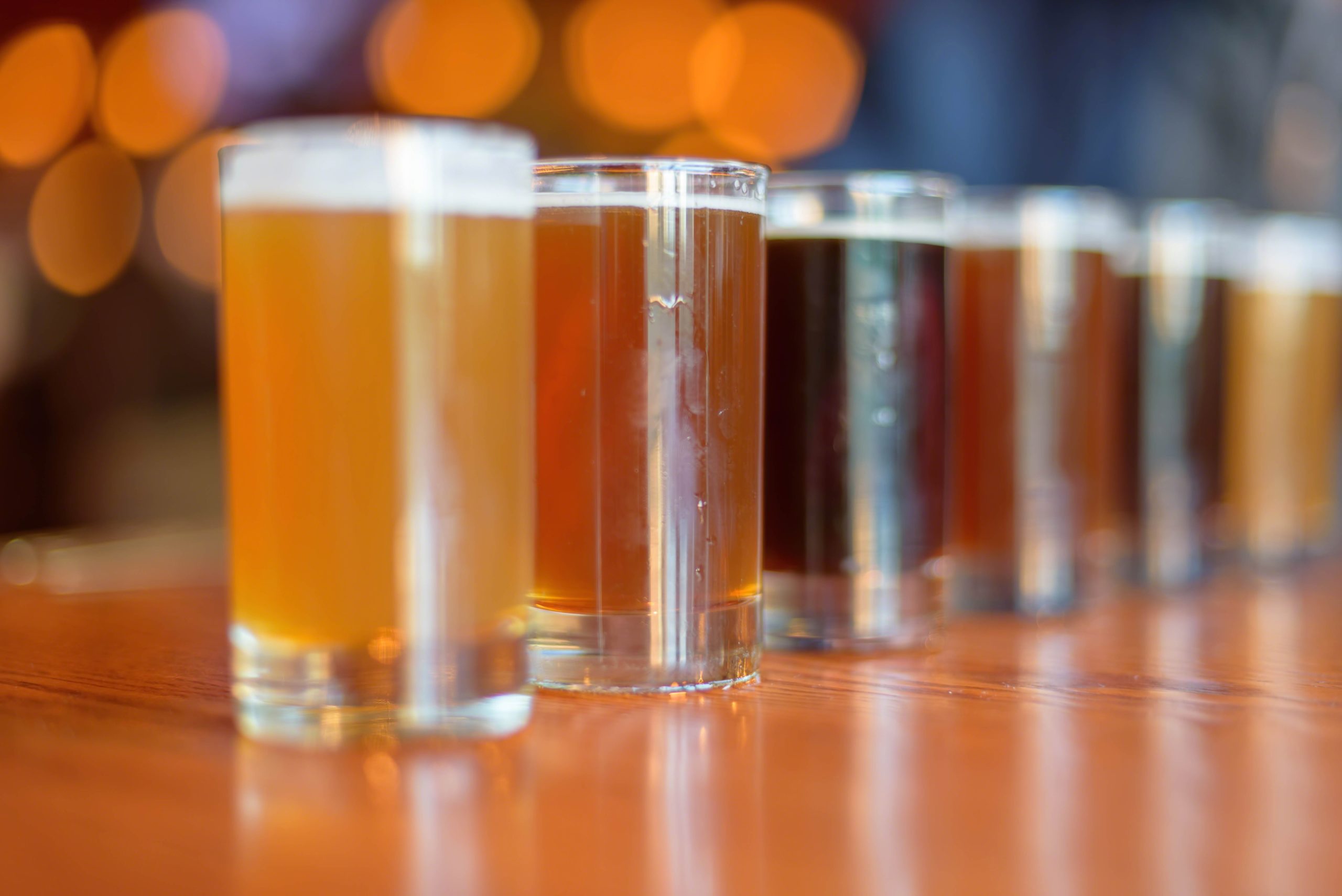 Low angle close up of beer flight lined up on the table